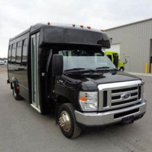 A black bus parked in front of a building.