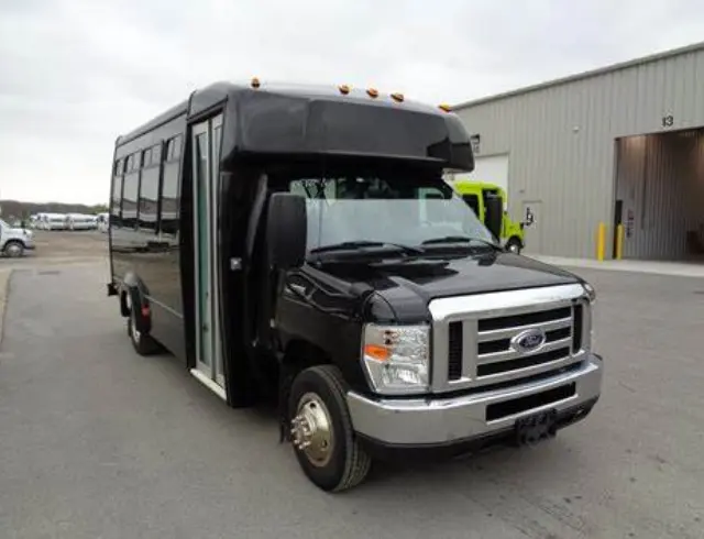 A black bus parked in front of a building.