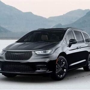 A black car is parked on the beach